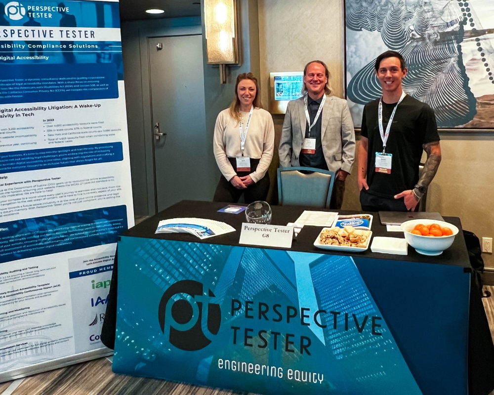 Jason, April, and Justin standing behind a table with a banner that says "Perspective Tester".